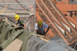 Qualified and licensed roof contractors repairing a damaged roof