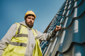 A roofing contractor wearing a hard hat