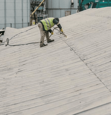 A roof installer in risk-preventing uniform