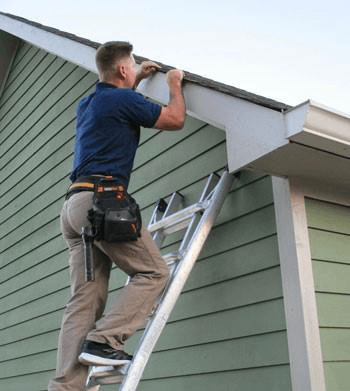 A roofing expert inspecting a metal roof