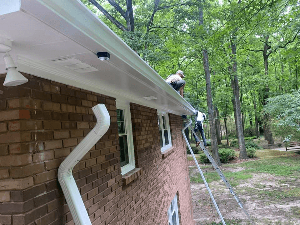 Rain gutter running down the side of a house’s roof 