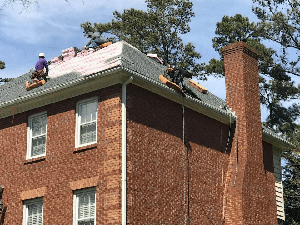 Handyman working hard to restore a roof in John Creek