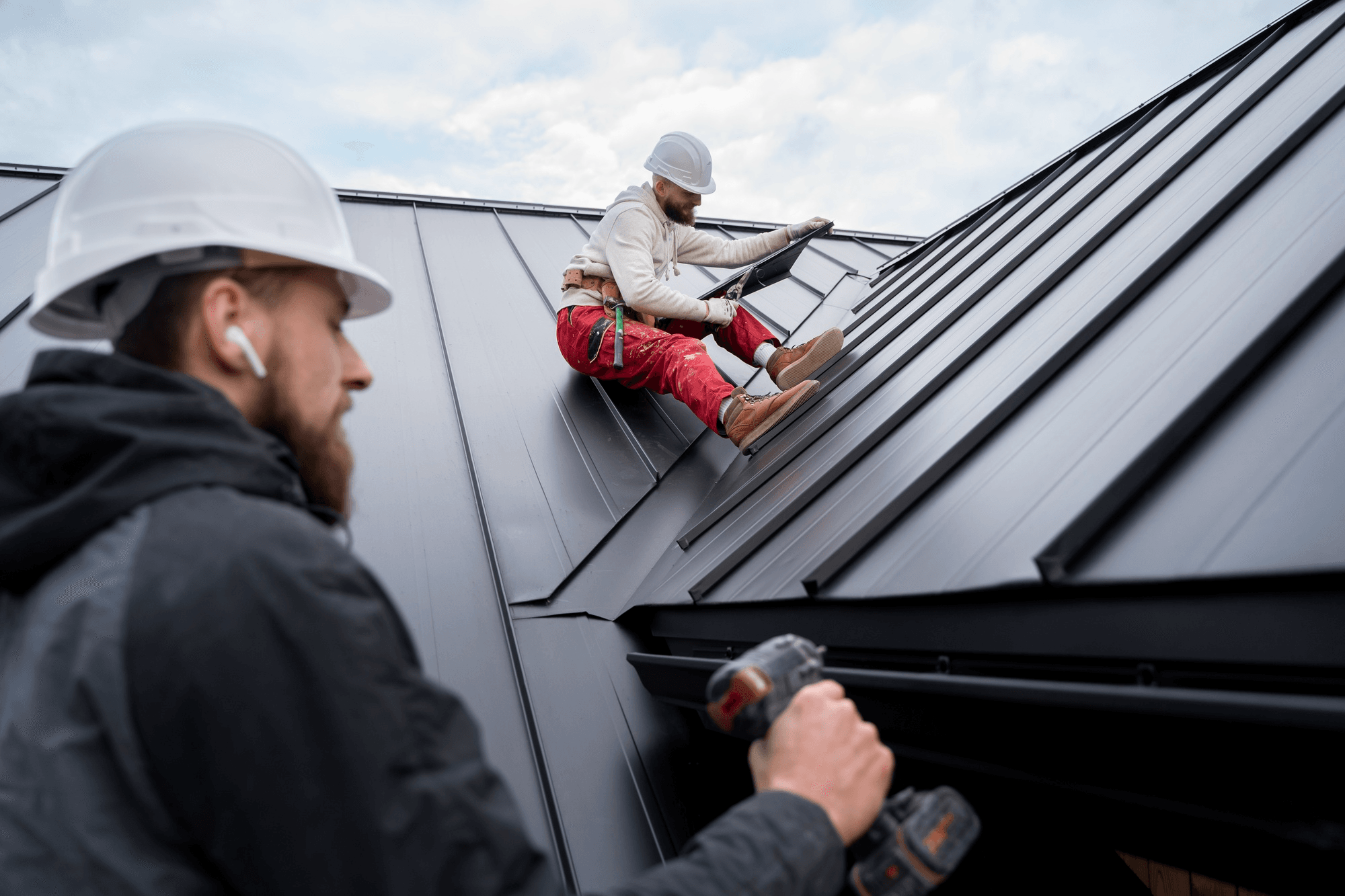 two roofing contractors at work