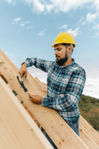 a roofing contractor hard at work fixing a roof post storm damage
