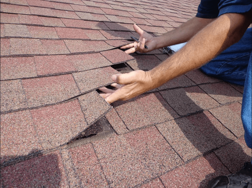A man inspecting a roof