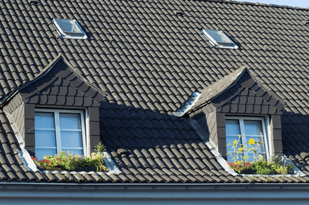 Well-maintained shingle roof with skylights after hail damage repair.