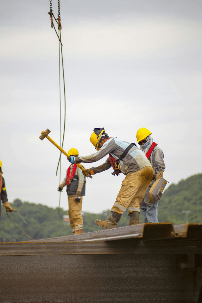 A roofing contractor in Lawrenceville, GA, holding a hammer during a commercial roof project.