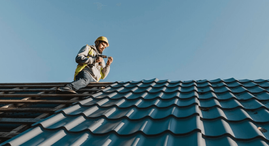Roofer working on the installation of asphalt shingles during a roofing project in Peachtree Corners.