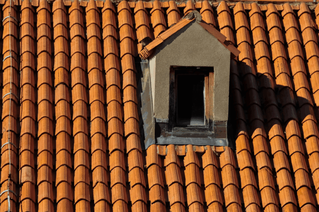 Sturdy asphalt roof topped with a decorative birdhouse reflecting durability and affordability.