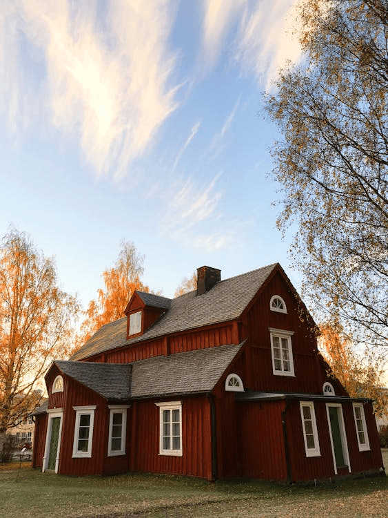 A well-maintained house during fall, showcasing the importance of a seasonal roofing checklist for protection and durability.