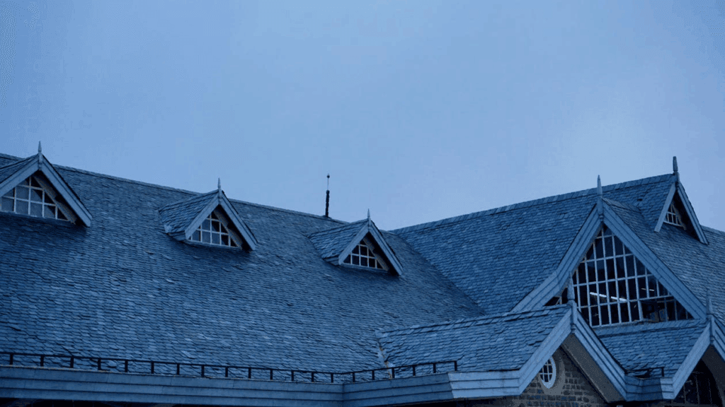  A house with grey shingles showcasing asphalt roofing after expert storm damage response and roof maintenance.