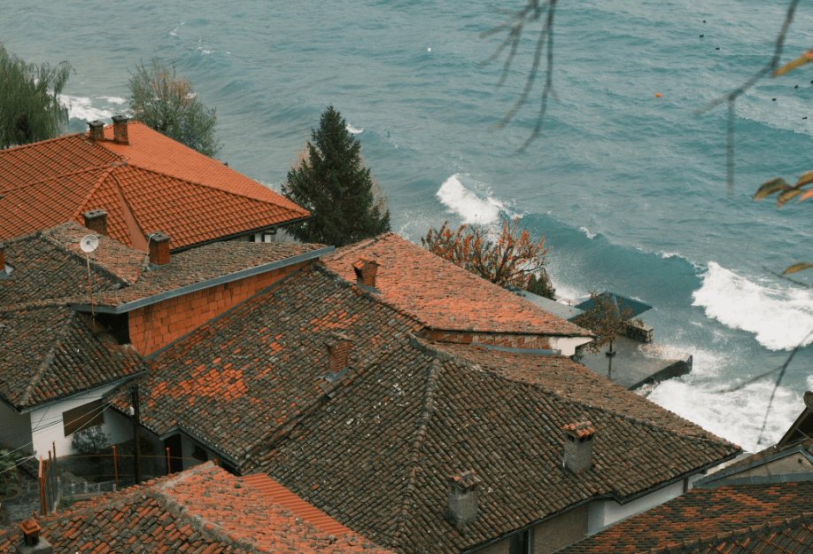 This image shows roof of houses near seashore.