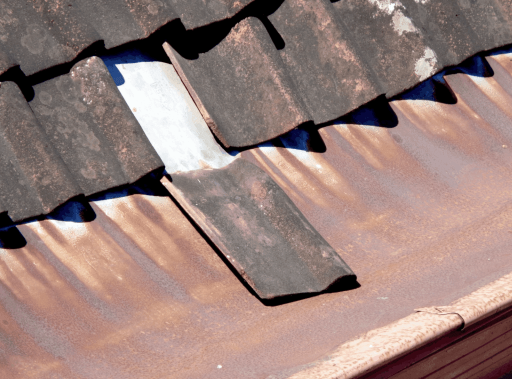 This photo shows a damaged and unfixed shingle on a roof.