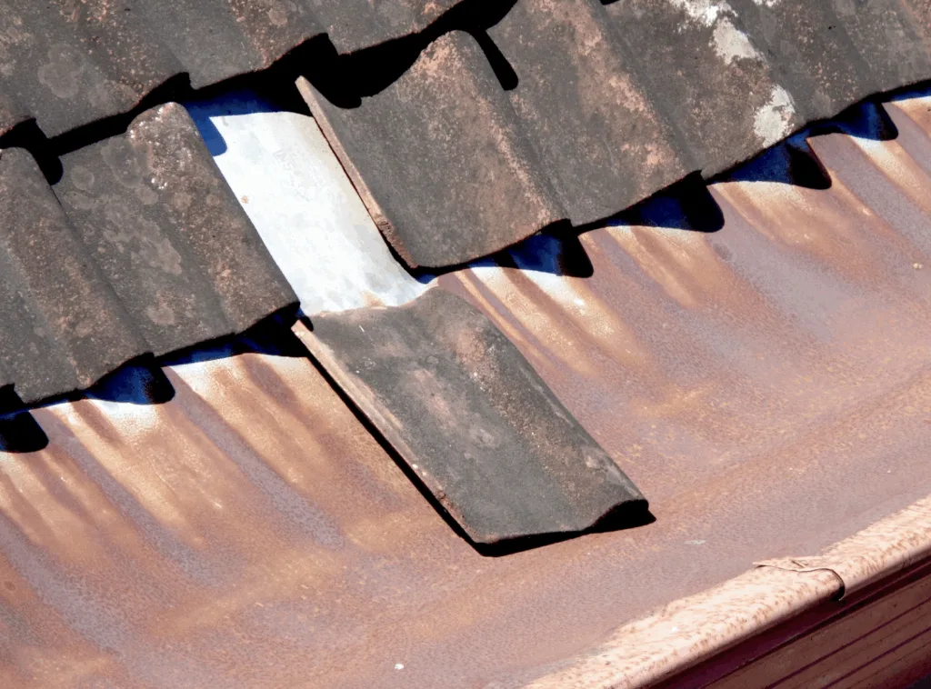 This photo shows a damaged and unfixed shingle on a roof.