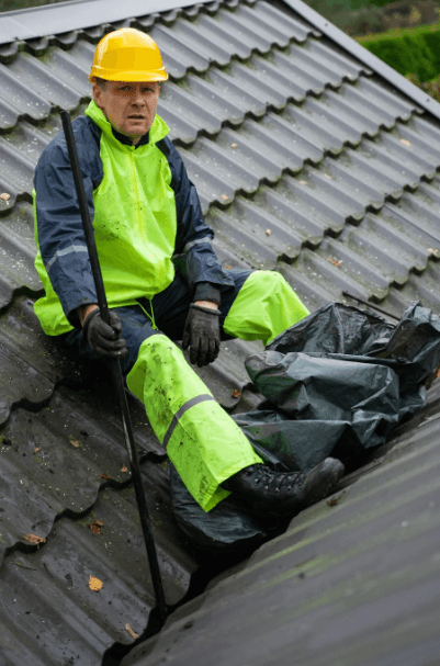 This image shows an expert technician is sitting on roof of a house.