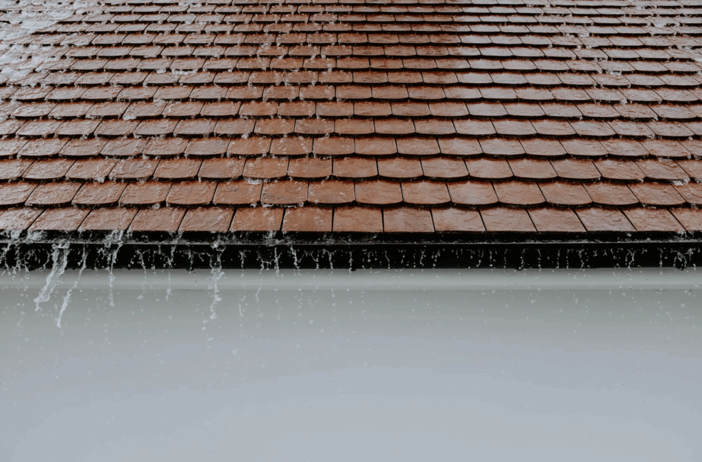 This photo shows a neat roof with heavy rain pouring on it.