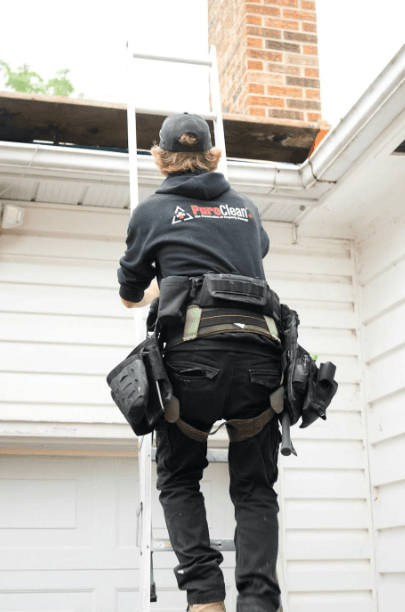 This image shows a man is inspecting a house roof.