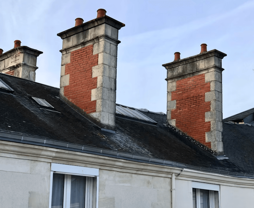 This image shows multiple chimneys on top of a building.