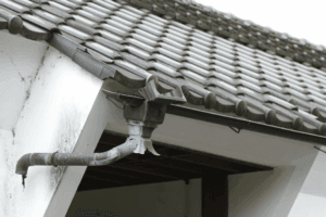 This image shows a roof with a pipe sticking out of it.