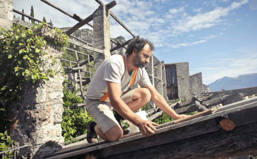 This image shows a man repairing his roof.