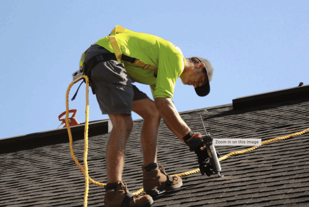 This photo shows house roof under bright sunlight with clear blue sky overhead background.