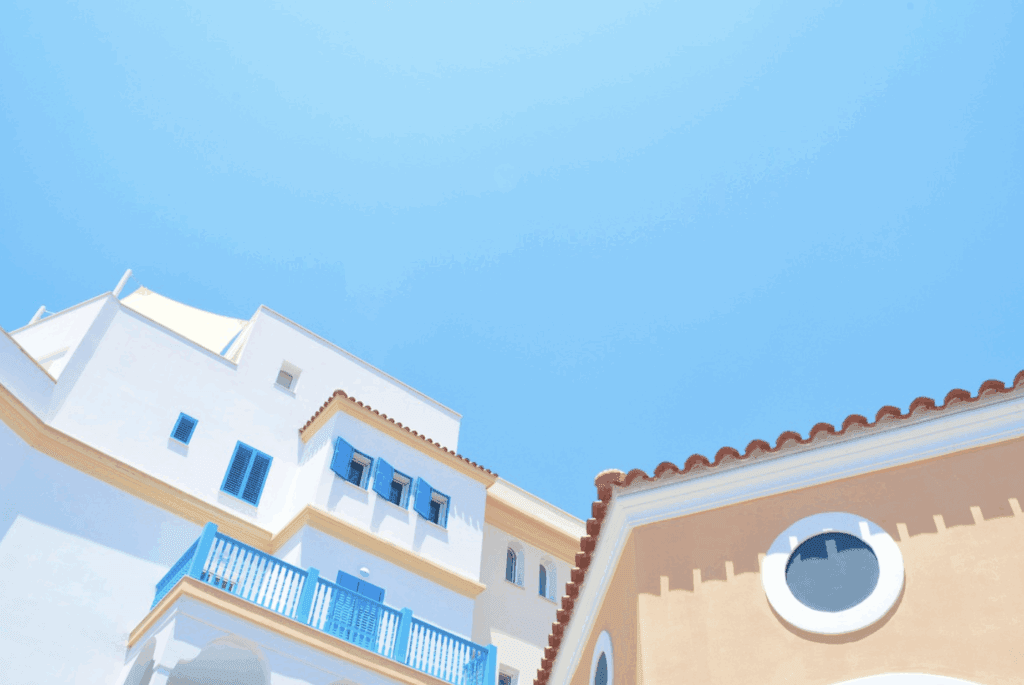This photo shows house roof under bright sunlight with clear blue sky overhead background.