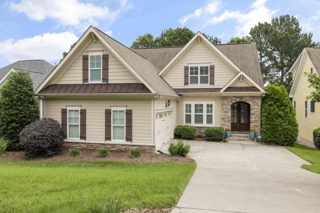 An image of a house with a lawn and trees.