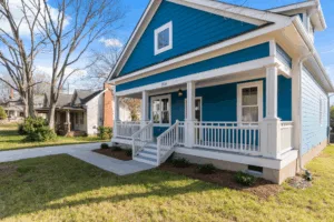 An image of a blue house under the blue sky.