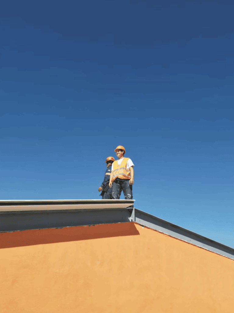 This photo shows a roofer inspecting the roof surface carefully, following severe weather conditions outside.